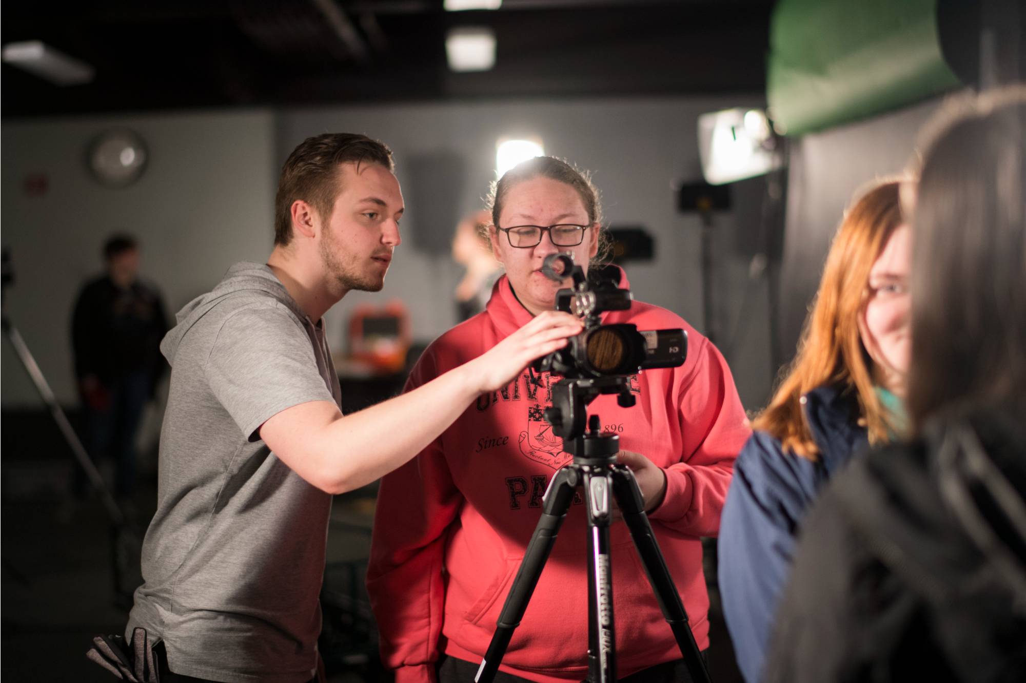 Film and Video students preparing for a filming session looking at a camera